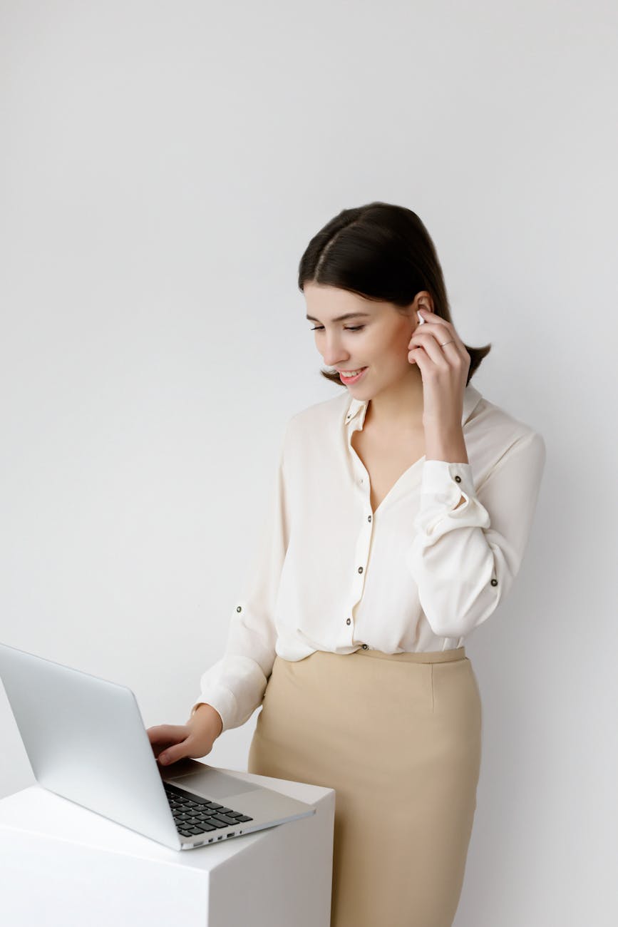 Office worker stretching at their desk with a smile.