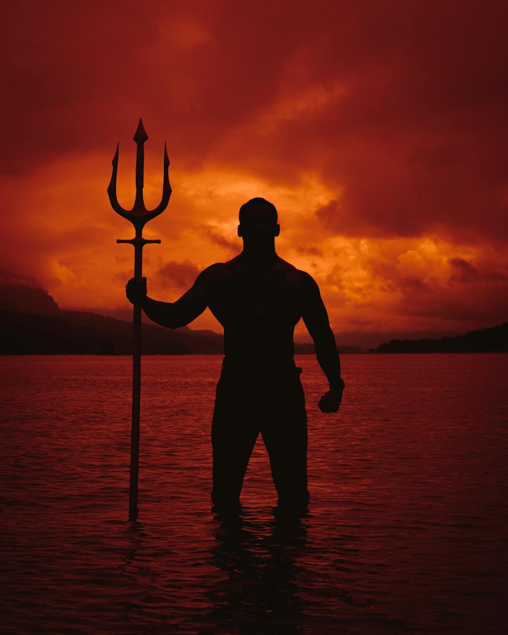 Silhouette of a person in a powerful pose at sunset.
